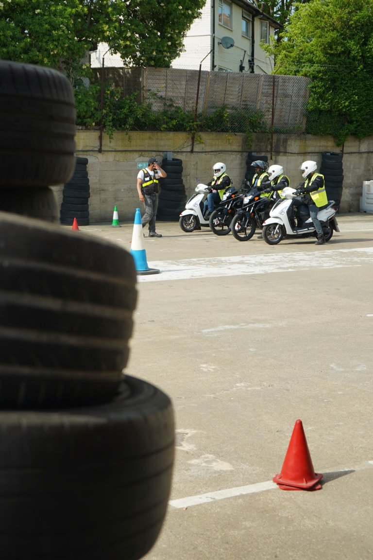 Instructor coaching a learner on a motorcycle - Universal Motorcycle Training Wimbledon centre